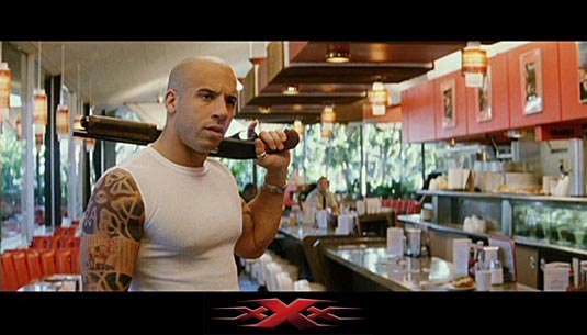 Vin Diesel holding a sawed-off Remington 870 shotgun as Xander Cage in XXX Vin Diesel holding a sawed-off Remington 870 shotgun as Xander Cage in XXX