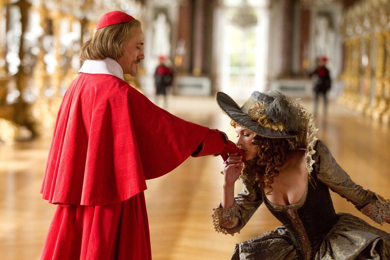 Milla Jovovich as M’lady De Winter and Christoph Waltz as Cardinal Richelieu in The Three Musketeers