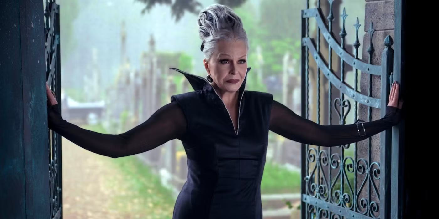 joanna lumley as grandmama hester frump standing between a gate in wednesday season